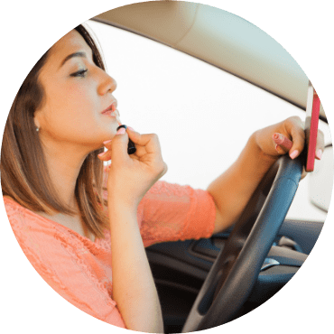 Woman putting on make-up while driving